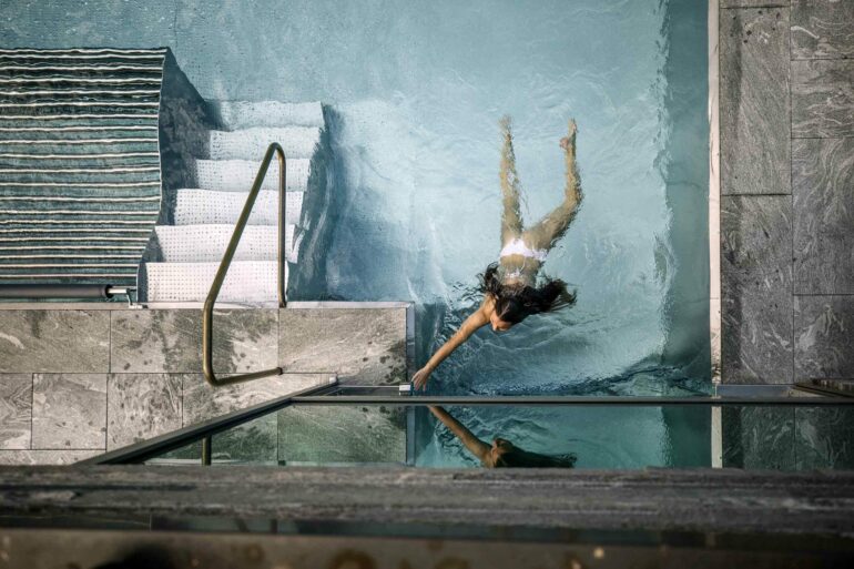 A guest swims in a pool at Hotel Arlberg, Lech, Austria