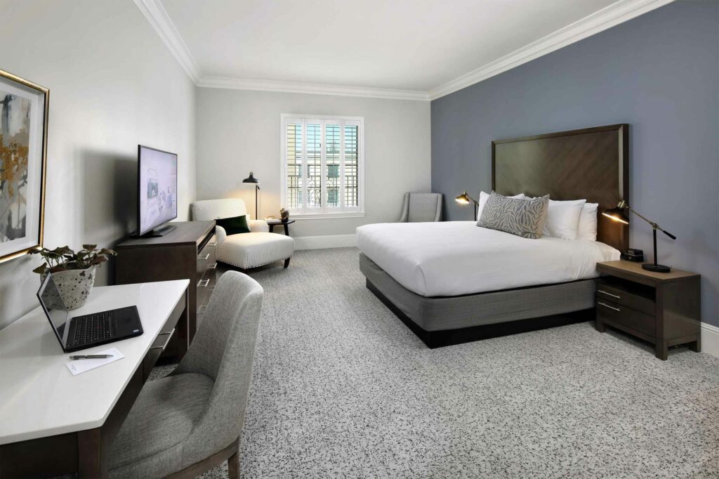A sophisticated spacious bedroom with a grey colour scheme.