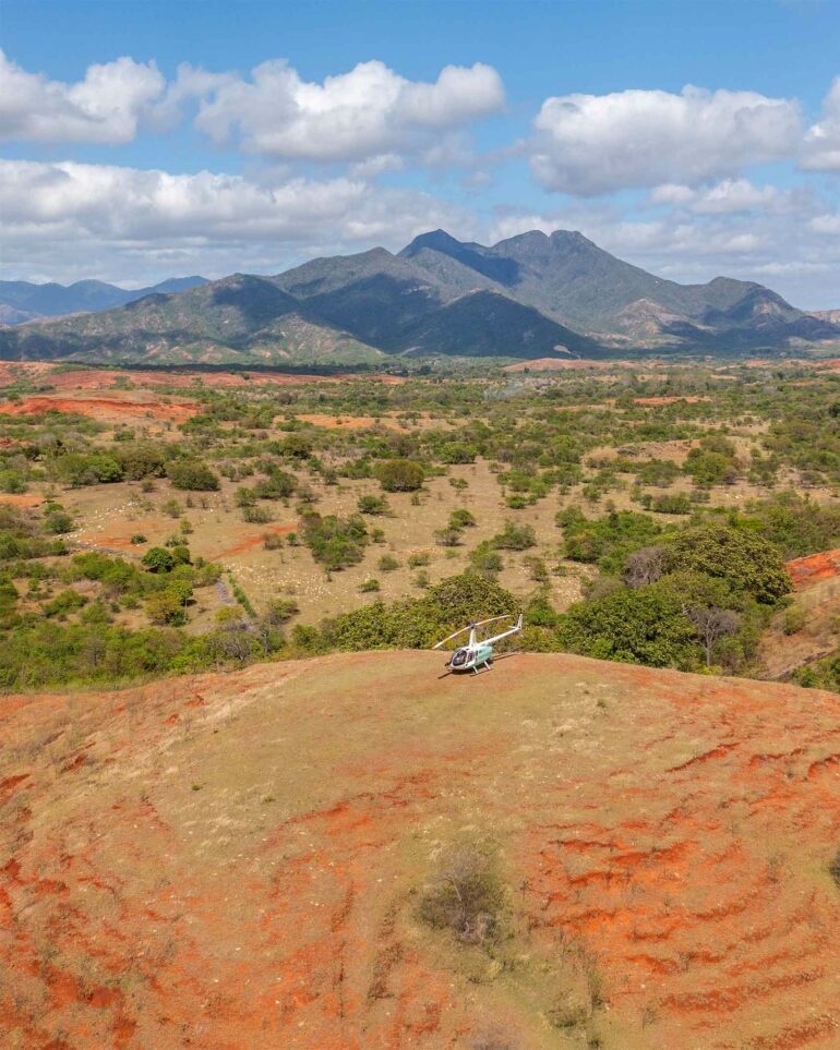A helicopter amidst a wide, open landscape in Madagascar