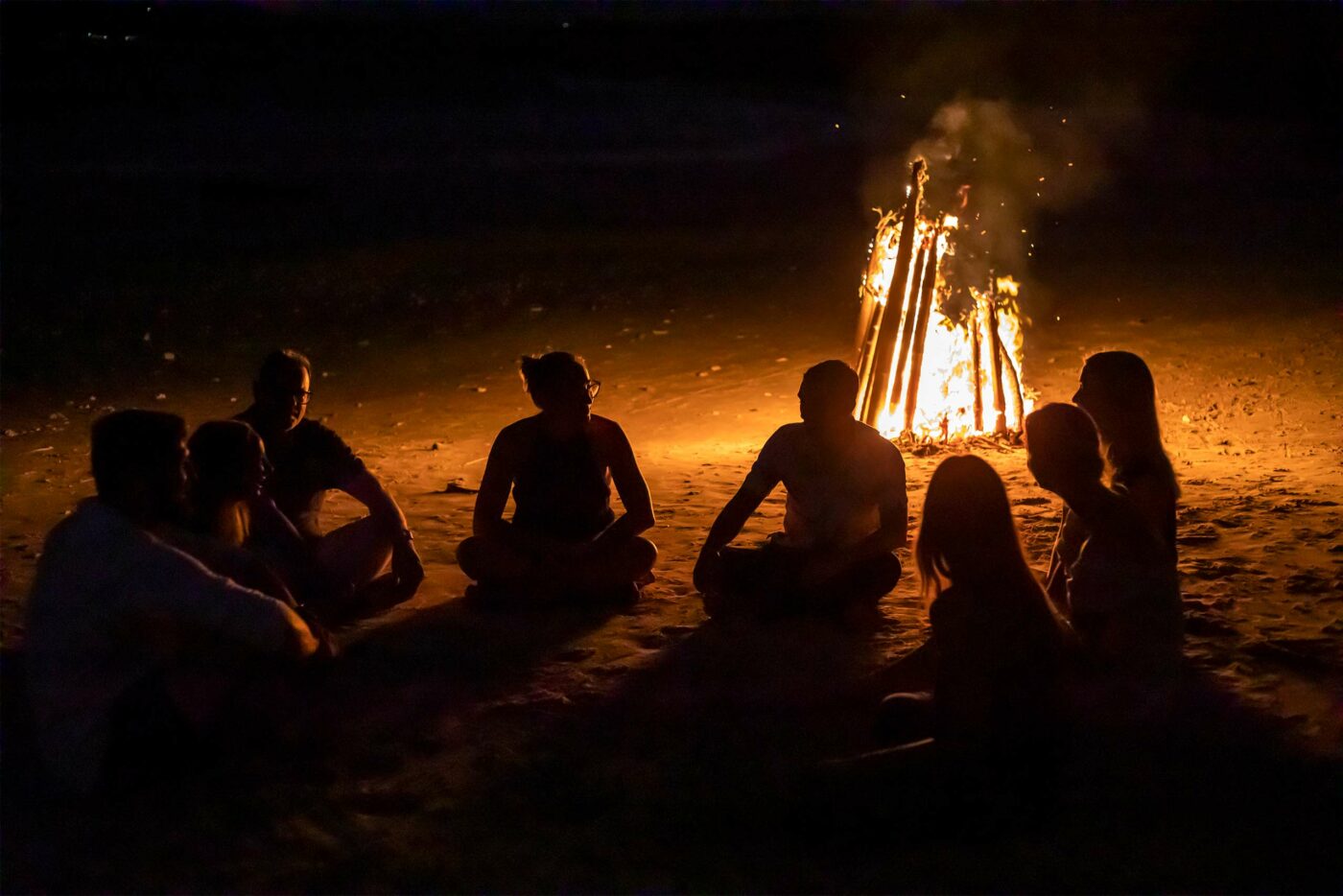Guests gather by a log fire at NIHI Sumba, Sumba, Indonesia