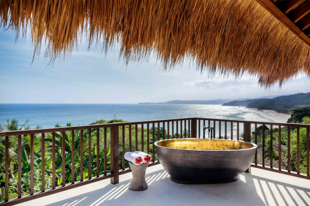 A bathtub affords stunning views over the sea at NIHI Sumba, Sumba, Indonesia