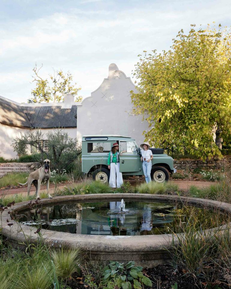 Fleur Huijskens and Nicole Boekhoorn pose by a water feature at Sterrekopje, Franschhoek, South Africa