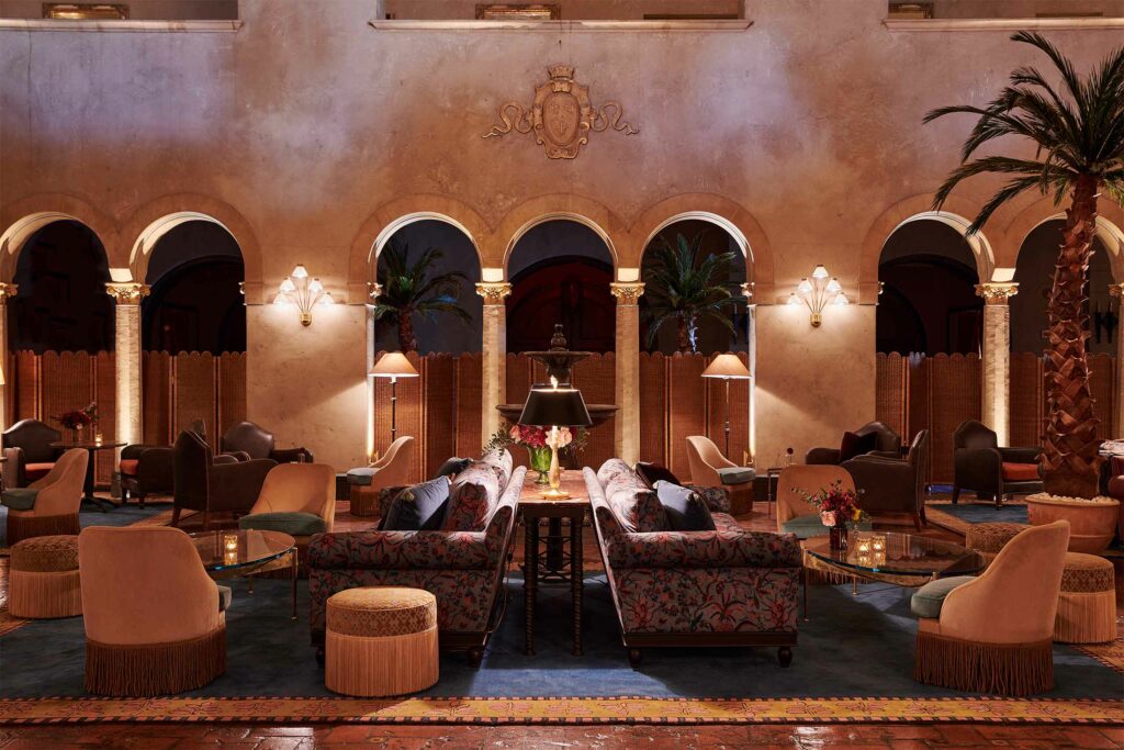 Lobby with palm trees and archways.
