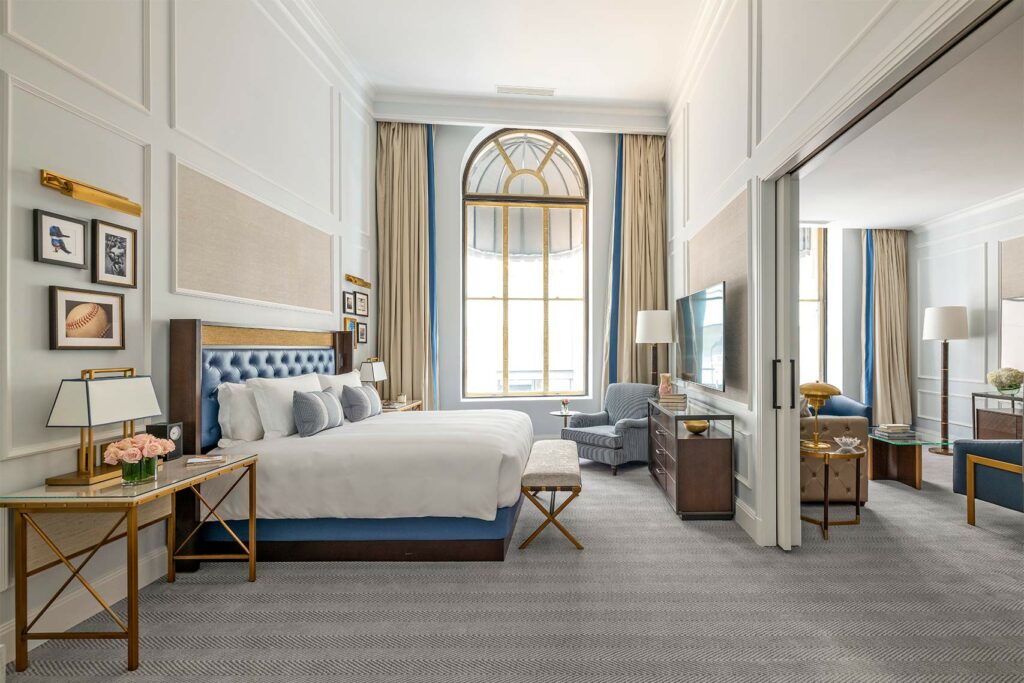 Spacious, breezy bedroom at The Langham, Boston sky blue accents.
