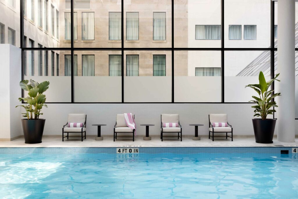 Pool at The Langham, Boston with a large window flooding the area with natural light.