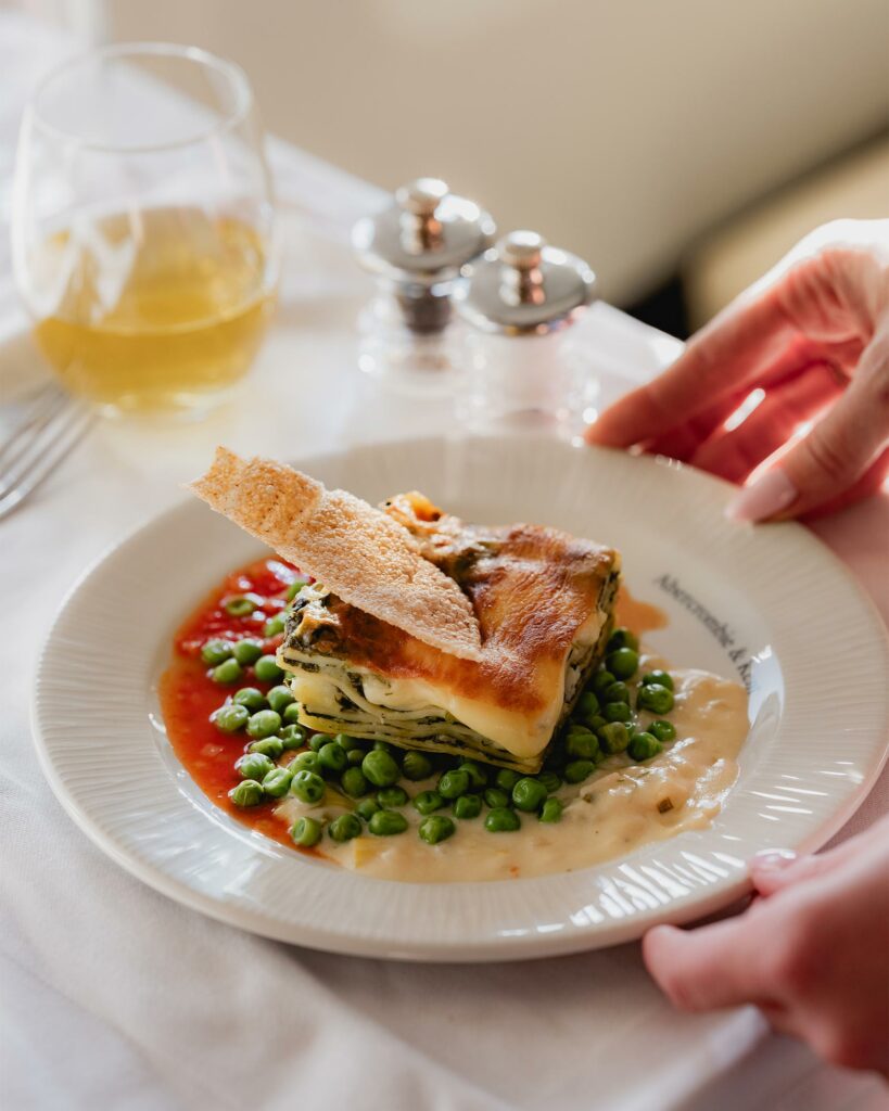 A carefully plated dish with white fish and vegetables. 