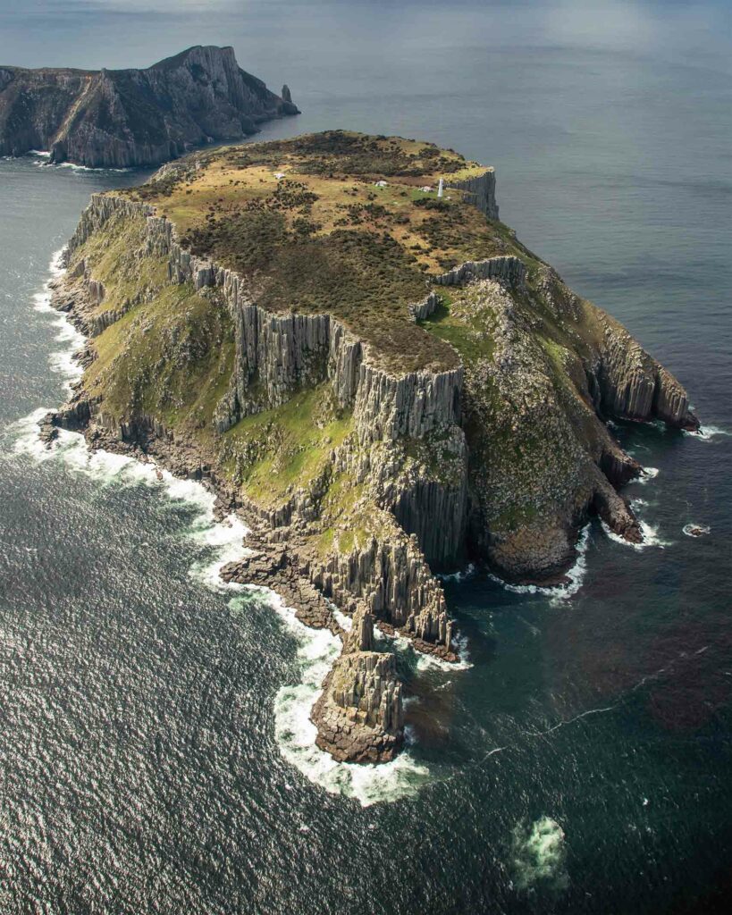 A mountainous island seen from the plane with Abercrombie & Kent Private Jet Journeys. 