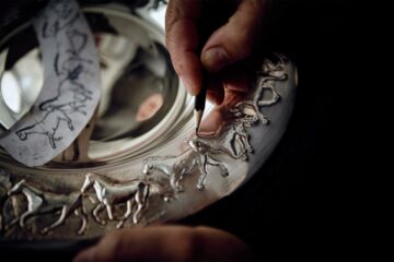 An artist chases horses onto a silver bowl at Hamilton & Inches during a Bespoke Edinburgh tour, Edinburgh, Scotland