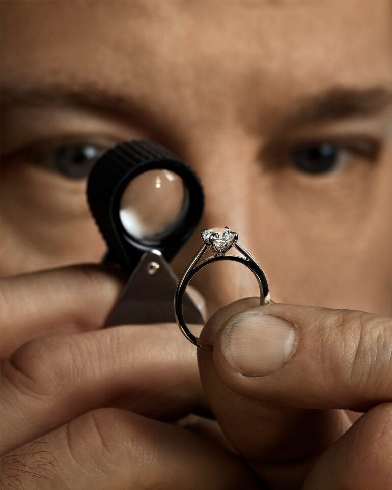 An employee of Hamilton & Inches inspects a ring
