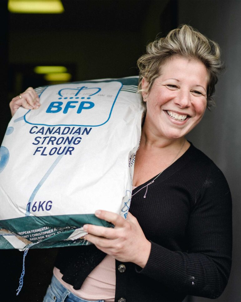 Lara Bross, founder of Bross Bagels, holds up a pack of flour. Bagels are a new addition to Scottish cuisine. Perthshire, Scotland