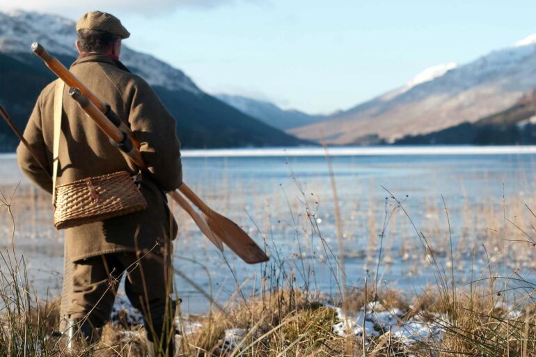 A local Scotsman stands by a Loch, Perthshire, Scotland