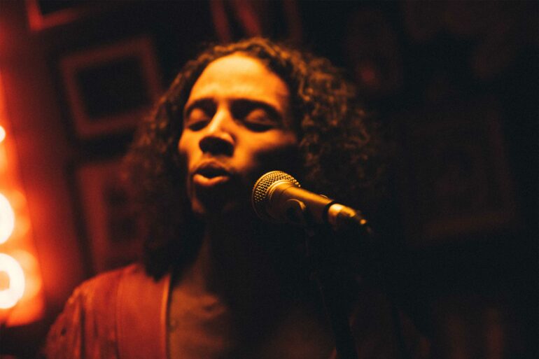 Al Clapper sings in a dimply lit room in Cape Town, South Africa