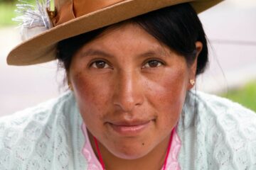 A Peruvian woman looks into the camera. The Explorations Company supports women across the country