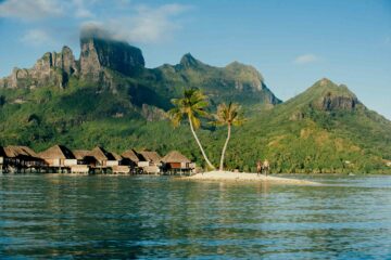 Gay couple on resort with mountains in the background on the Islands of Tahiti