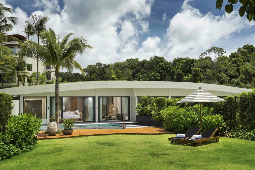 Beachfront Pool Villa exterior with its smooth green lawn.