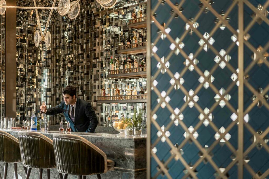 The opulent Bar Trigona with a bartender preparing a drink.