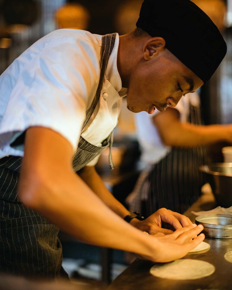 A staff member prepares a meal at Test Kitchen Fledgelings, Cape Town, South Africa
