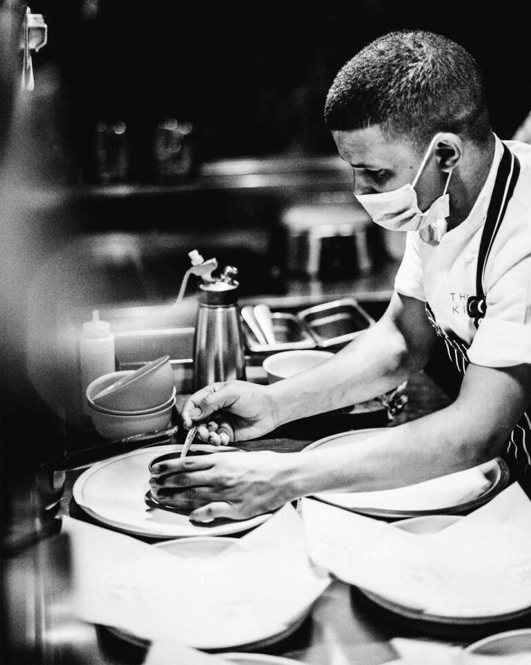 A chef wears a face mask while readying a dessert at Test Kitchen Fledgelings, Cape Town, South Africa