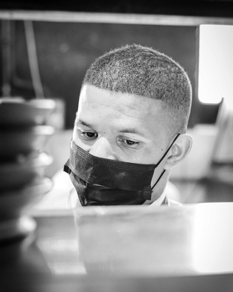 A staff member wears a face mask in the kitchen at Test Kitchen Fledgelings, Cape Town, South Africa