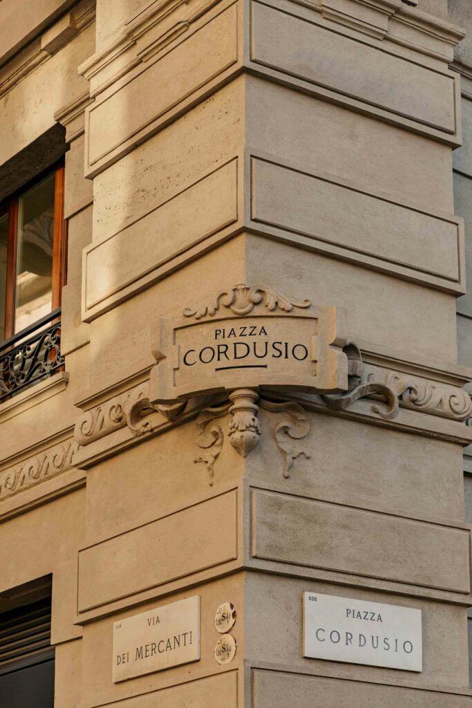 Palazzo Cordusio Gran Meliá exterior and street sign