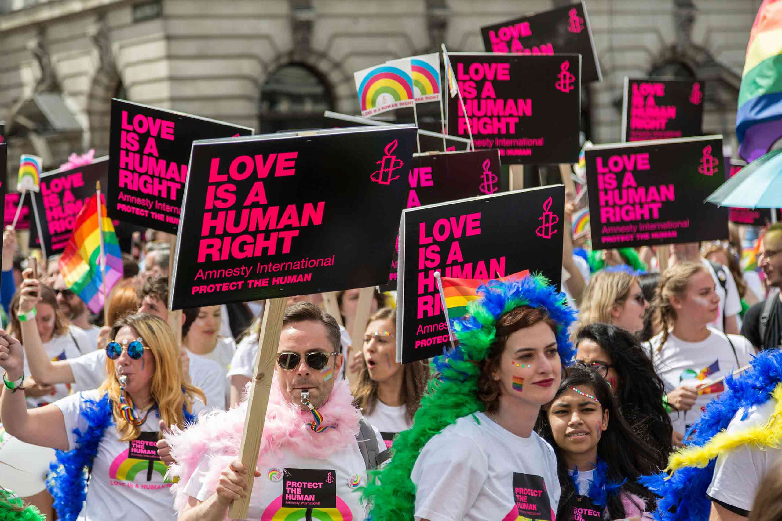 Amnesty International supporters with Love is a Human Right placards at Pride in London