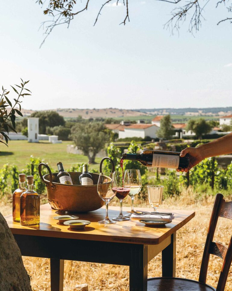 A staff member pours a glass of red wine at São Lourenço do Barrocal, Alentejo, Portugal