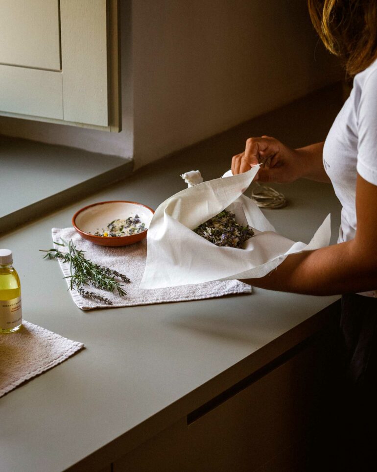 A staff members lays out dried lavender at São Lourenço do Barrocal, Alentejo, Portugal