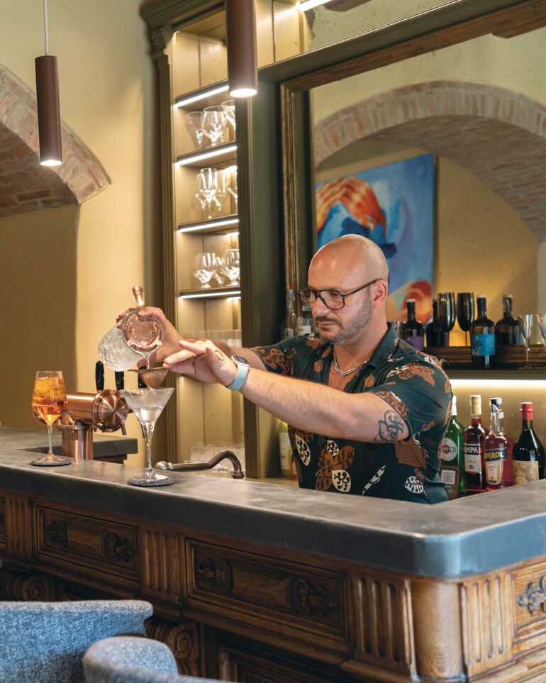 A barkeeper mixes a cocktail at Villa Ardore, Tuscany, Italy