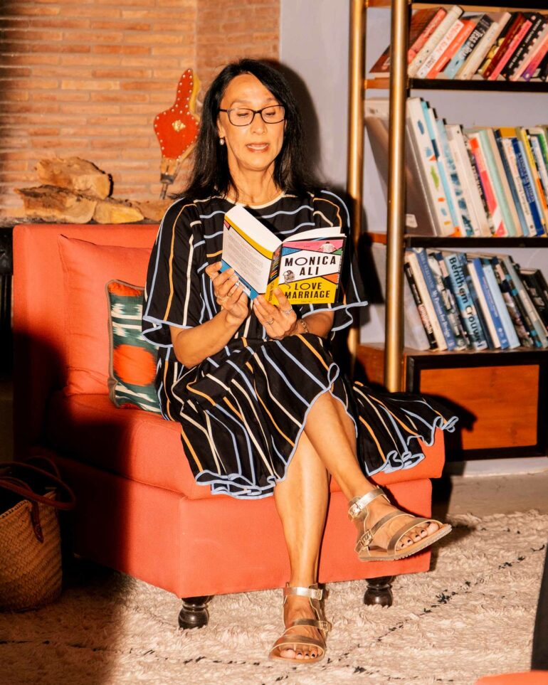 An attendee of a writing retreat by Silk Road Slippers reads from a book in Marrakech, Morocco