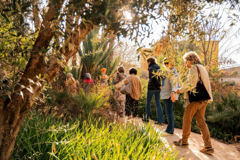 Attendees on a garden tour during a writing retreat by Silk Road Slippers, Marrakech, Morocco