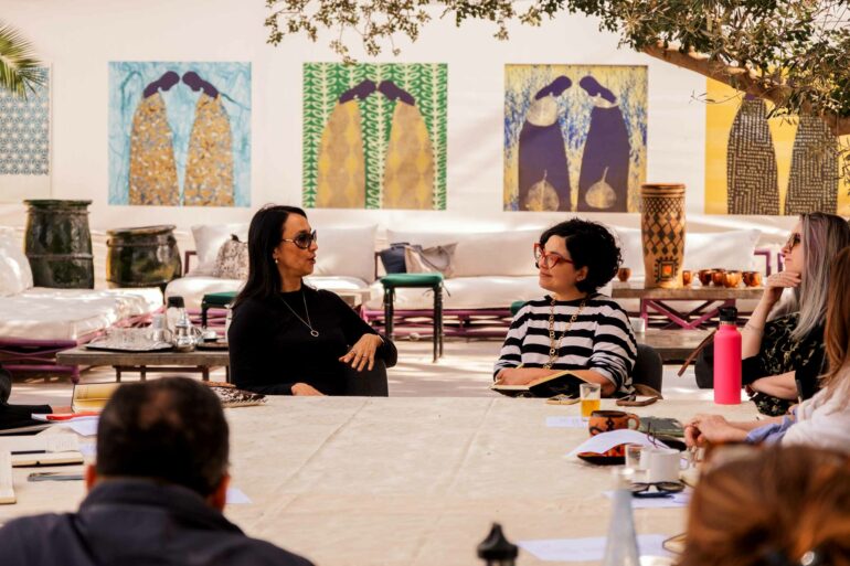 Two attendees involved in a discussion during a writing retreat by Silk Road Slippers, Marrakech, Morocco