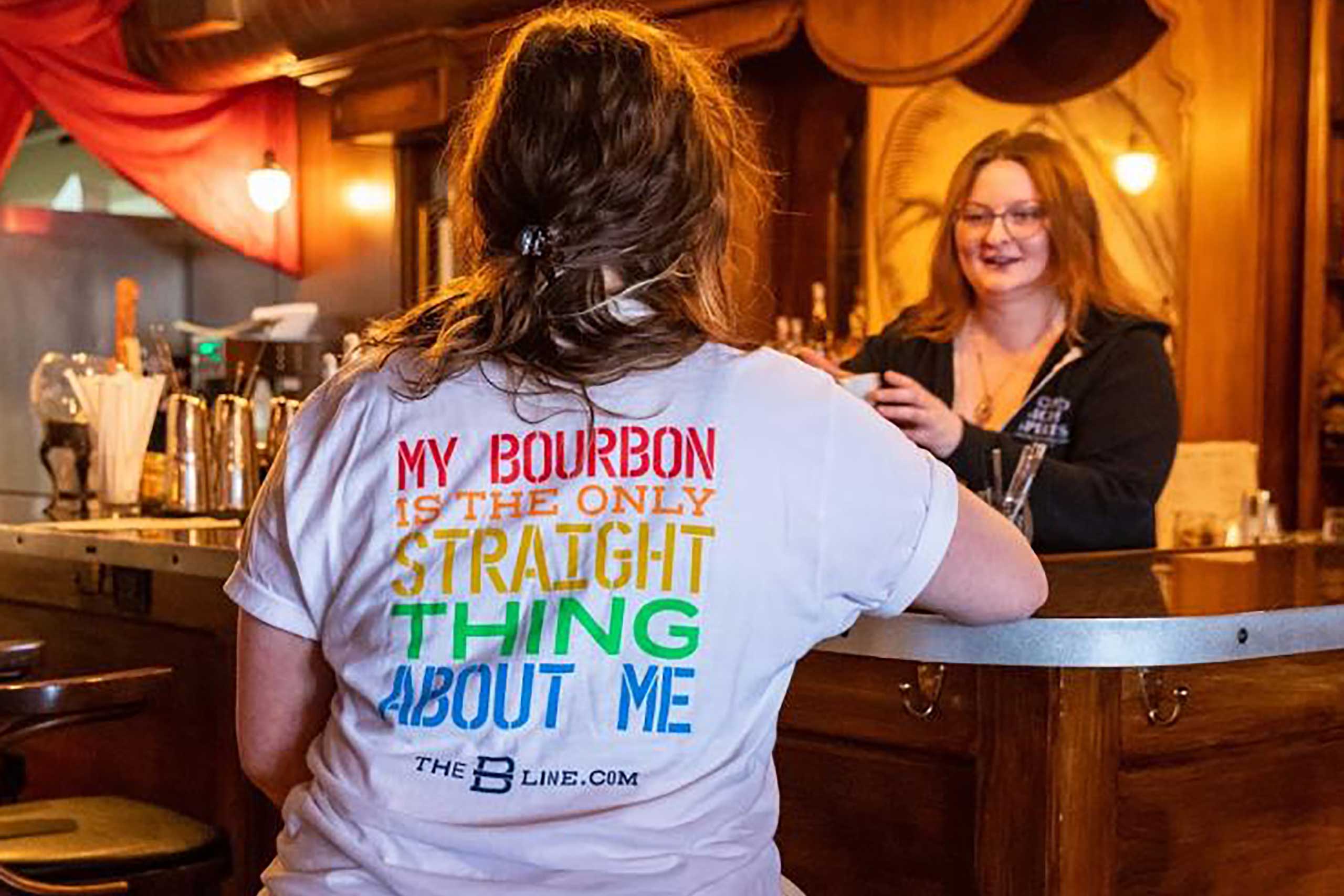 Person wearing 'My Bourbon is the only thing that is straight about me' t-shirt