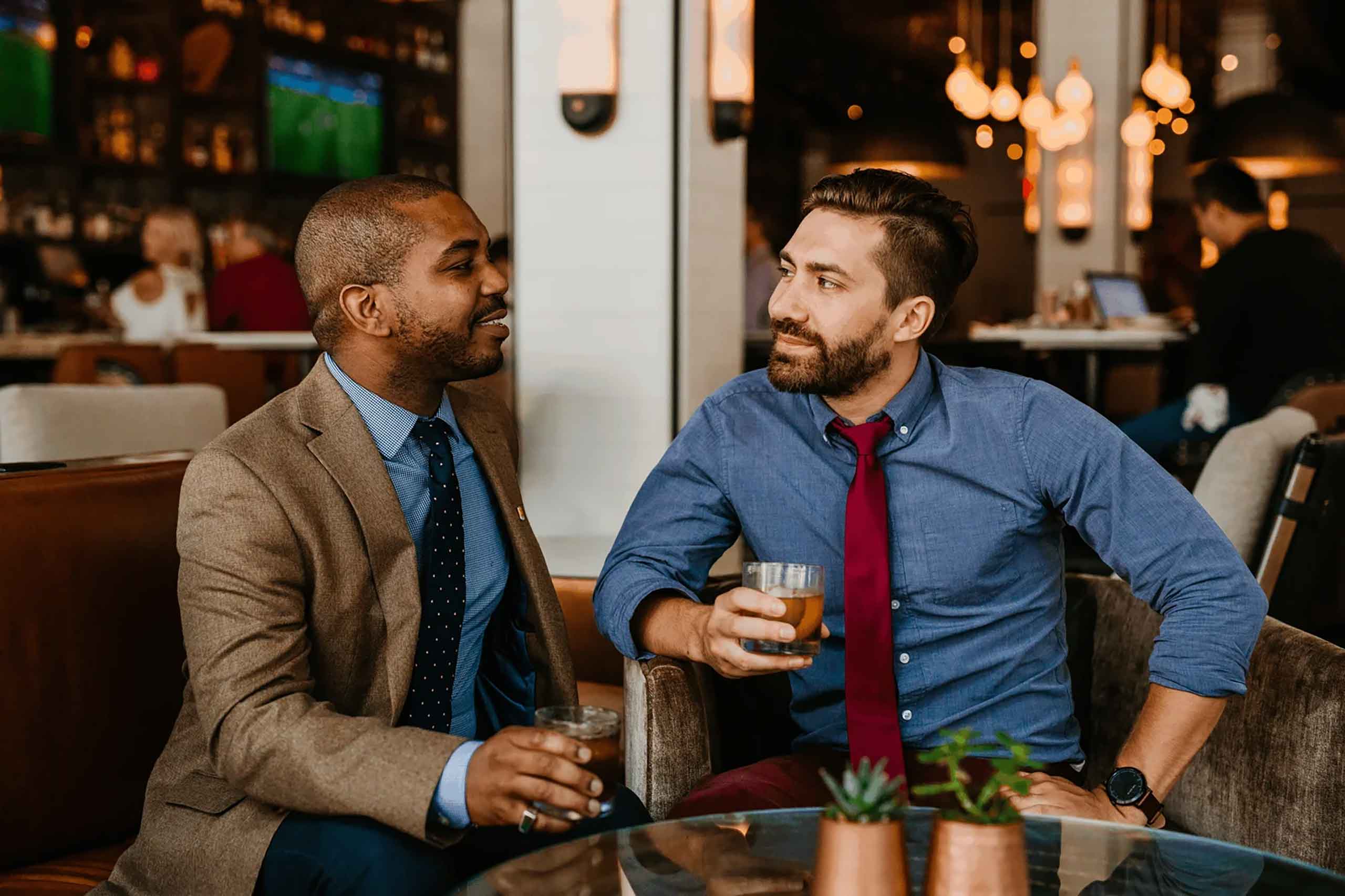 Two gay men enjoy bourbon at Bourbon & Belonging