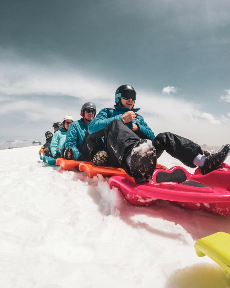 Visitors go tobogganing in Les Deux Alpes, France