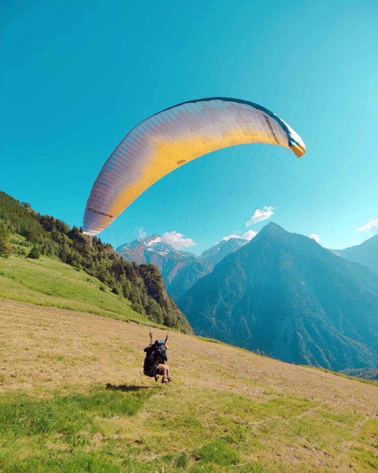A visitors goes paragliding in Les Deux Alpes, France
