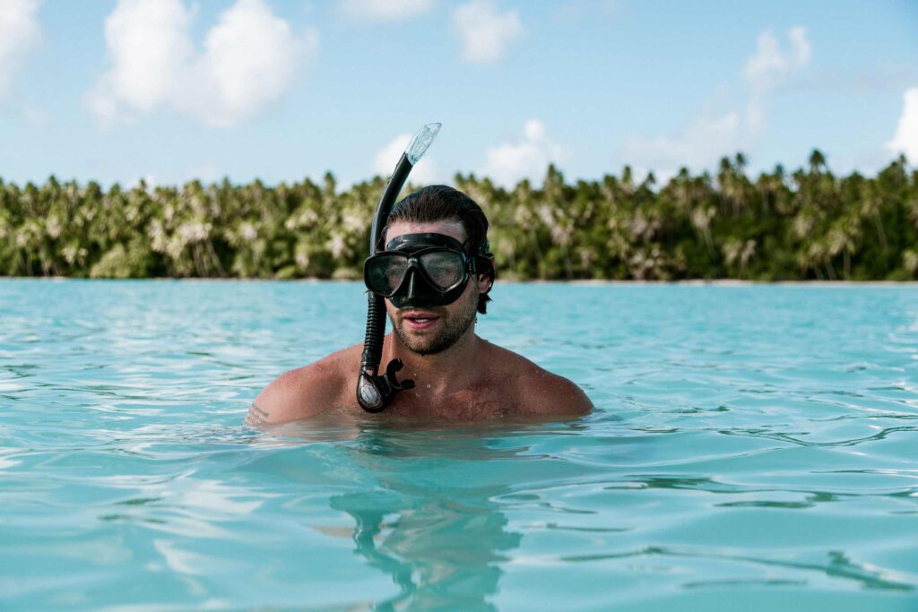 Snorkeller experiencing the beauty of the Queens Bath in French Polynesia