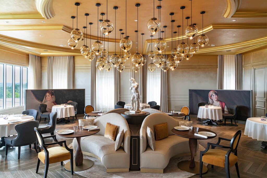 An arty public space at the Royal Champagne Hotel & Spa with a small statue at its centre - Chic stays outside of Paris.