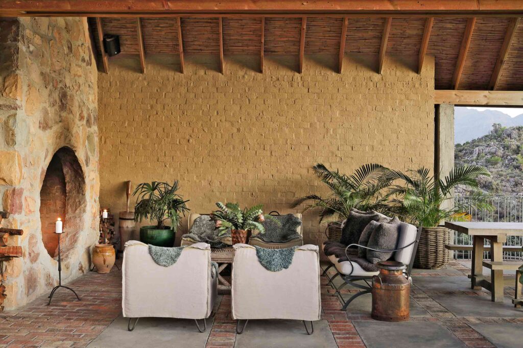 Outdoor seating by a fireplace at 7 Koppies, Franschhoek, South Africa