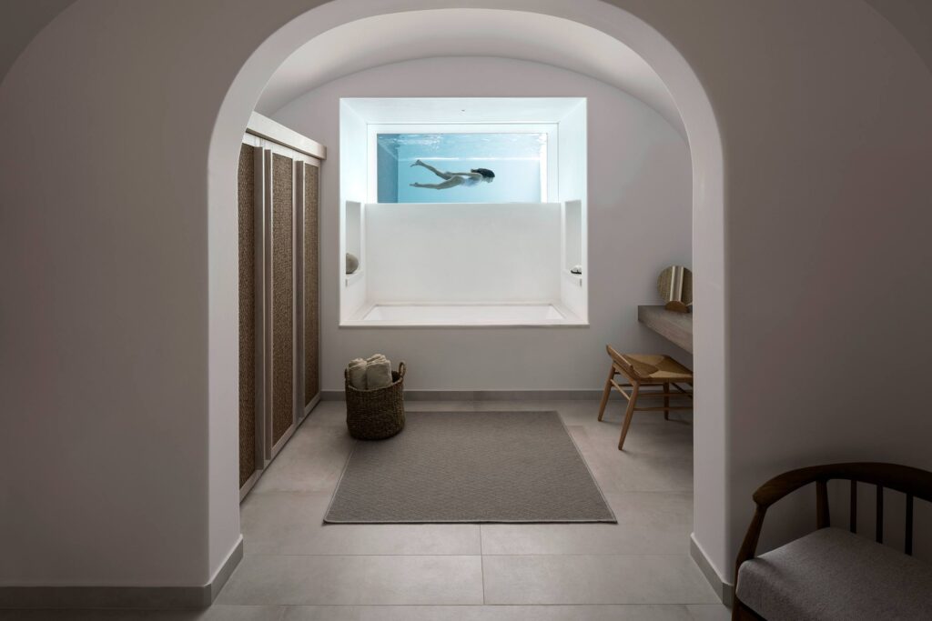 A guest swims in a pool of a private suite at Canaves Epitome, Oia, Santorini, Greece