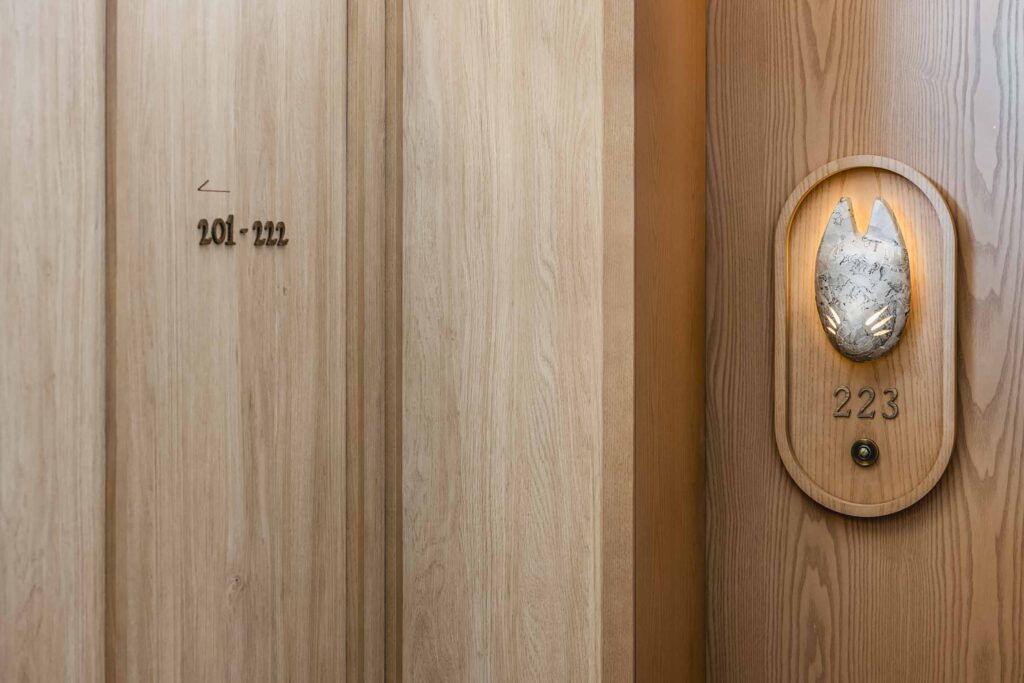 Papier-mâché inari fox masks light up room numbers