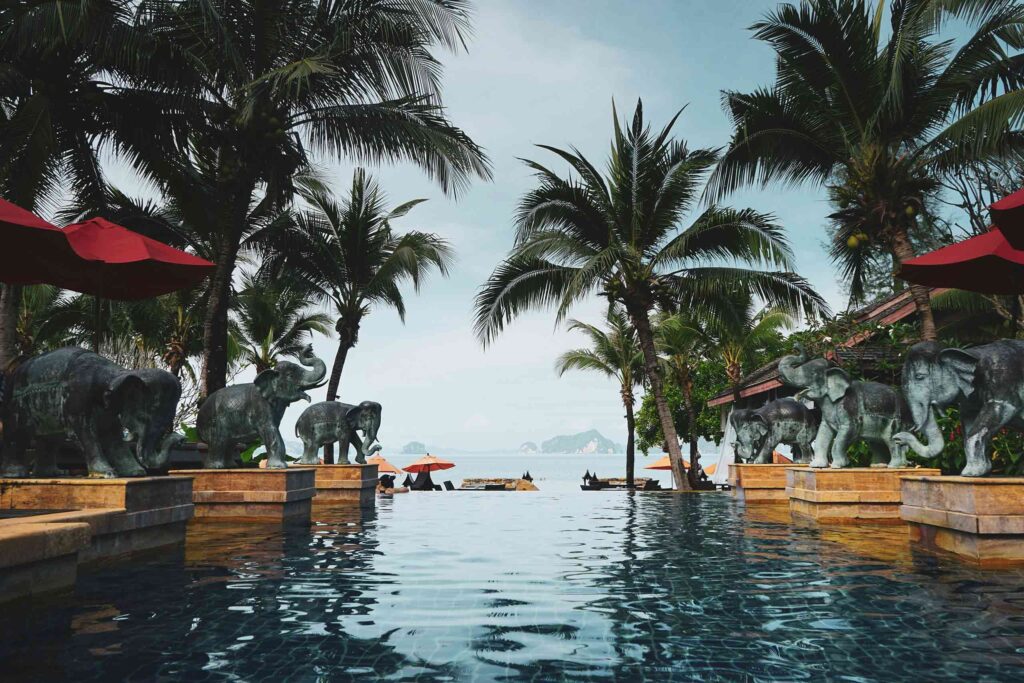 Luxury resort pool flanked by elephants overlooking the sea in tailor-made Thailand