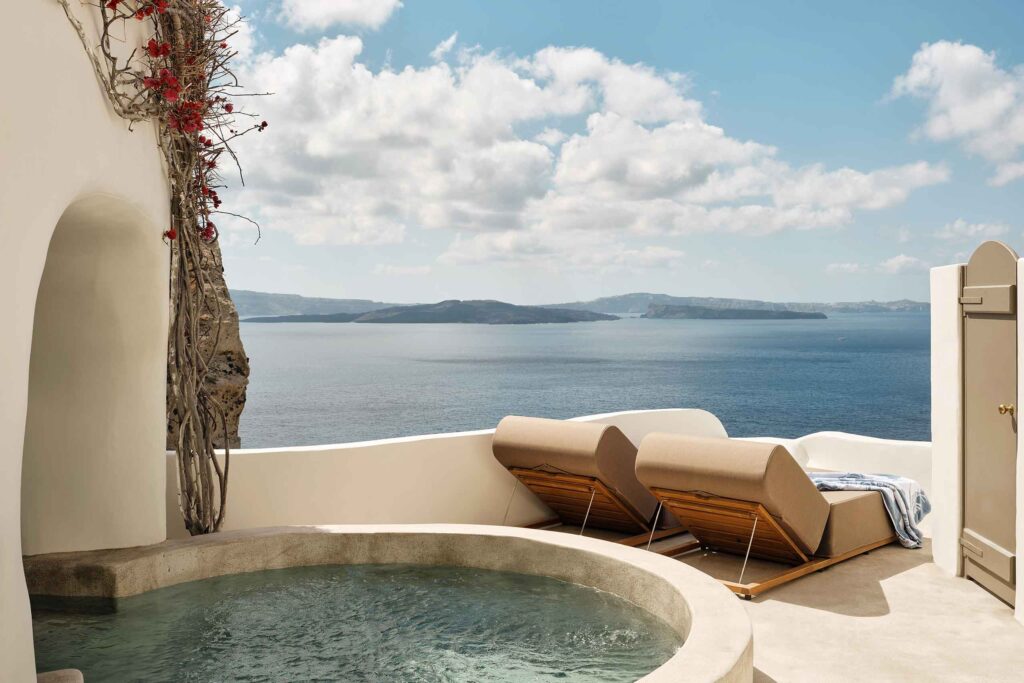 Plunge pool and sun loungers overlooking the Caldera at Oia Santorini