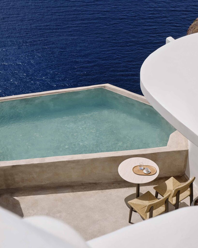 Infinity plunge pool with light blue water merges seamlessly with the Aegean sea