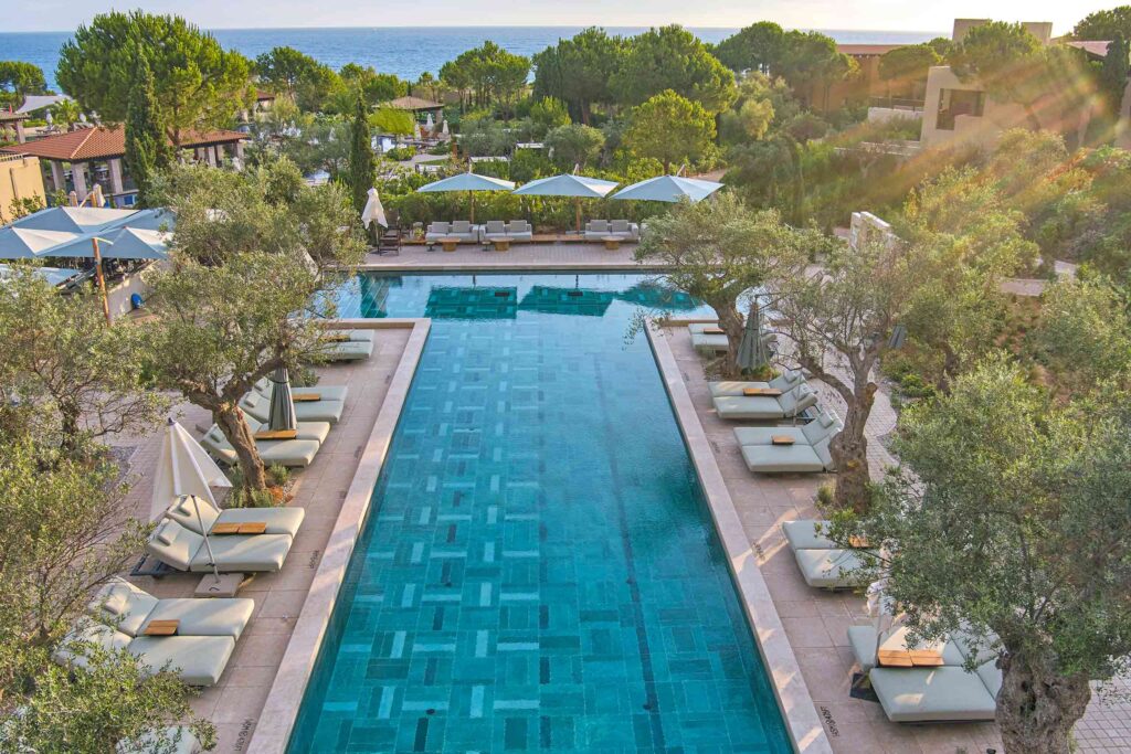 Pool flanked by olive trees at The Romanos, Costa Navarino