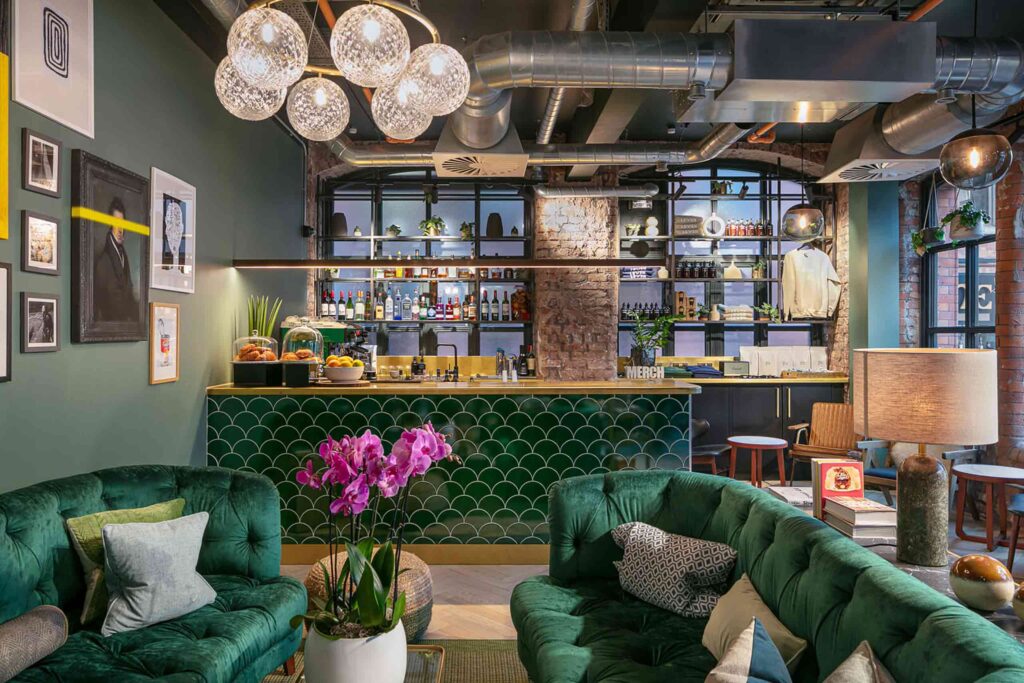 Green velvet and tile, interiors of reception at Leven Manchester