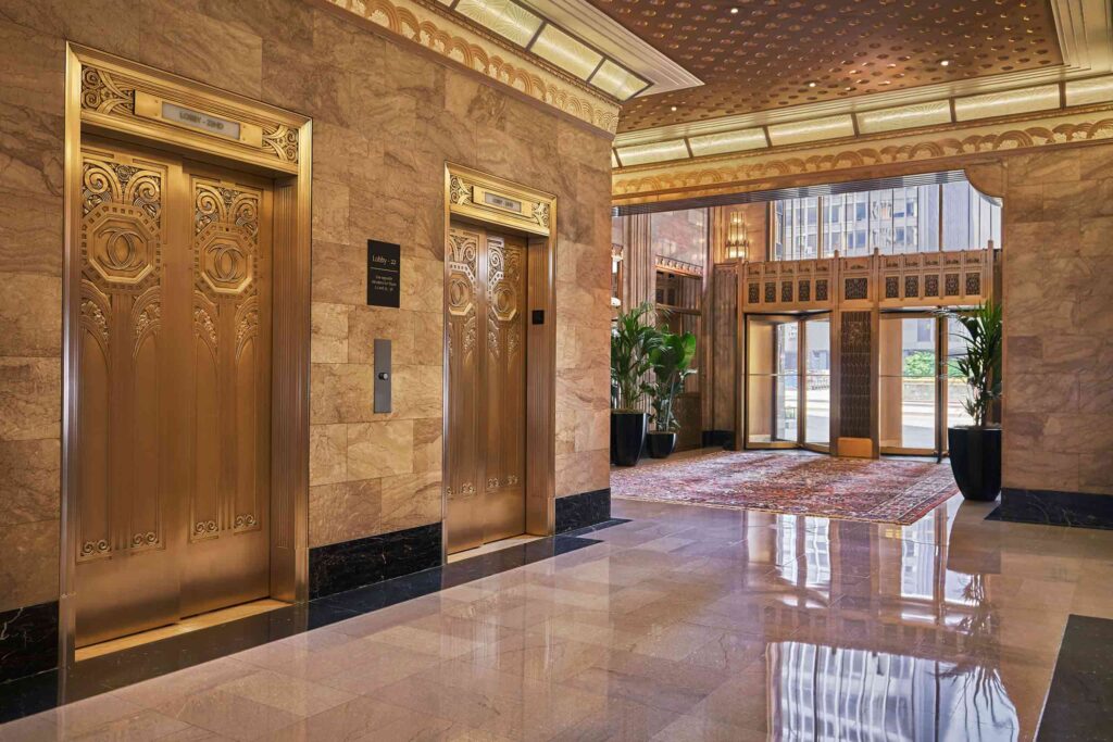 Marbled elevator lift lobby, with gold doors at the Carbon and Carbide building in Chicago