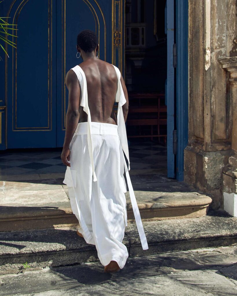 Fah Sampaio walks up the stairs of a historical church in Salvador, Brazil