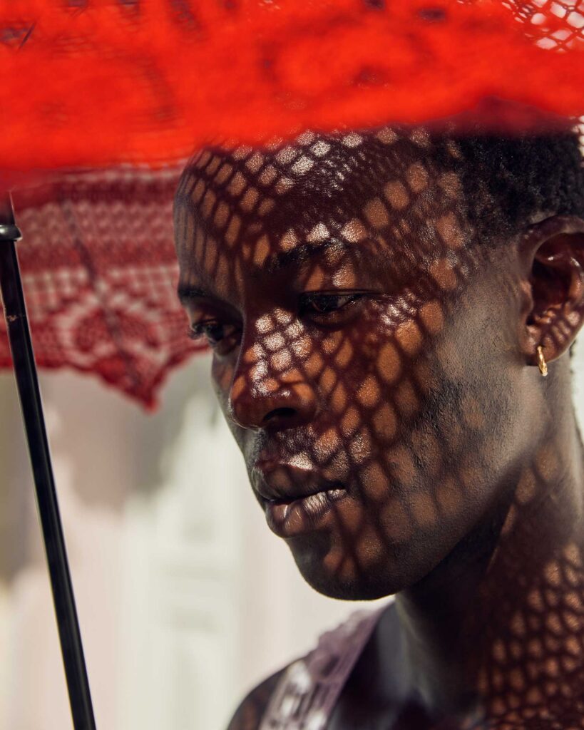 Fah Sampaio models a red parasol in Salvador, Brazil