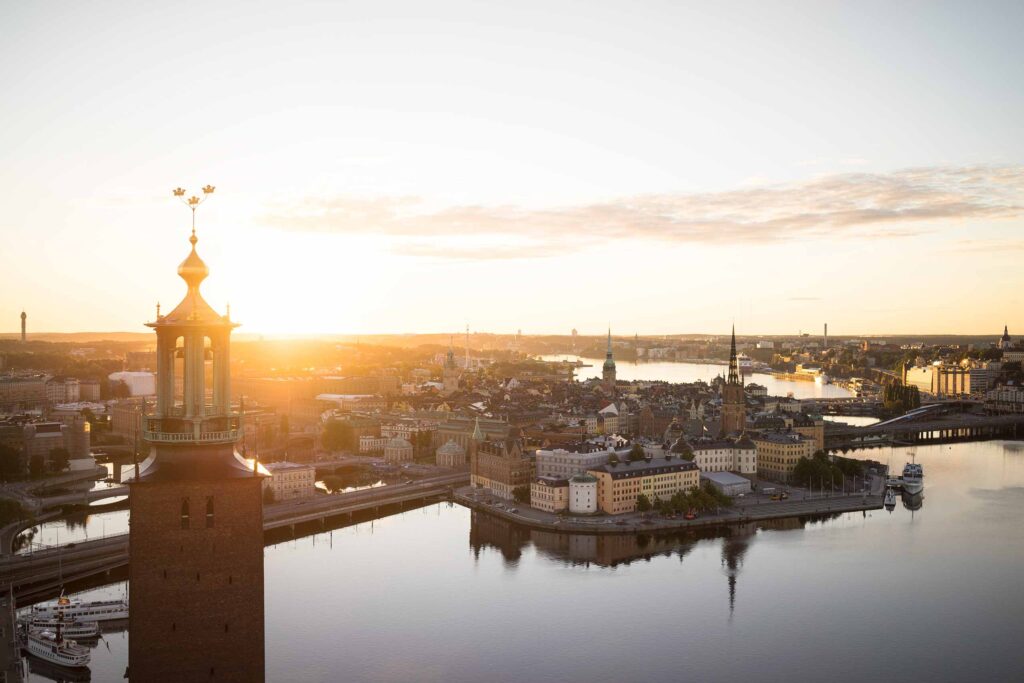 Cruise into the open city – Sunset over the city of Stockholm with golden hour shining reflecting its golden light over the old town of Gamla Stan and the water