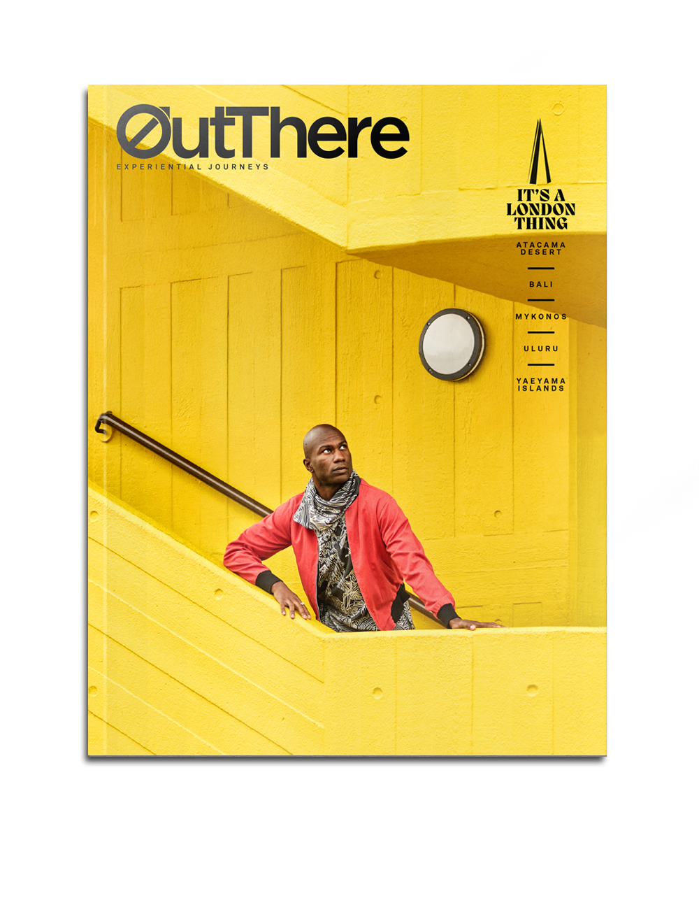 The It's a London Thing Issue of OutThere magazine, featuring a black model with a red jacket and brown and white scarf standing on a bright yellow stairwell